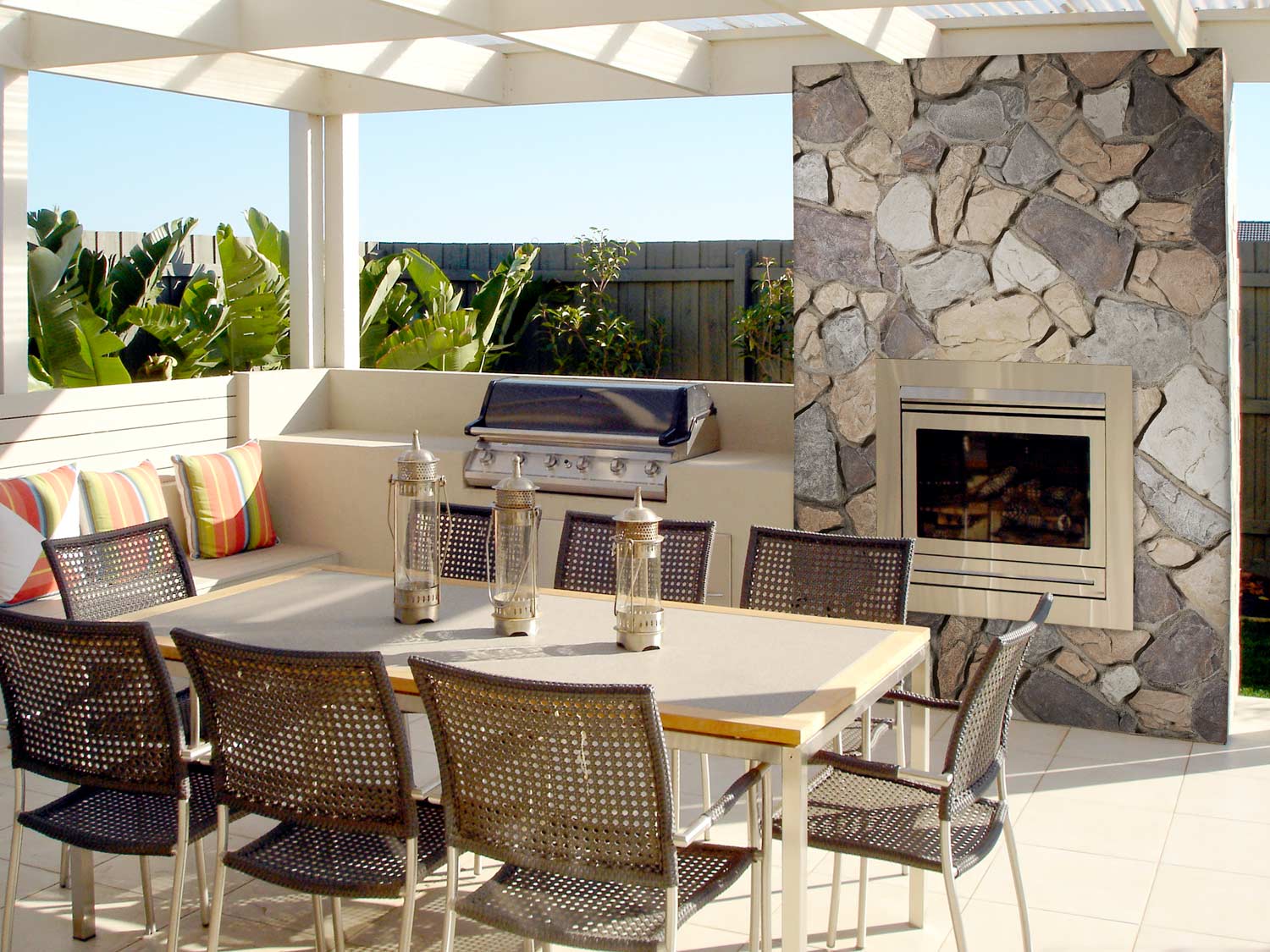 Faux stone panels placed around outdoor pool area fireplace