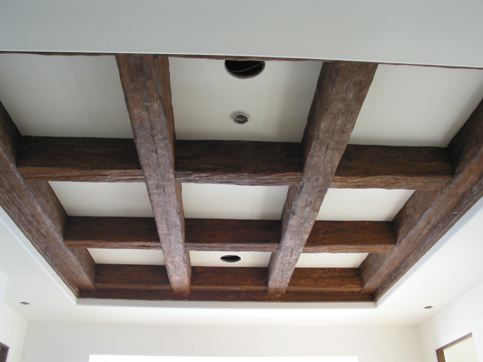 Coffered ceiling design created with faux timber beams.