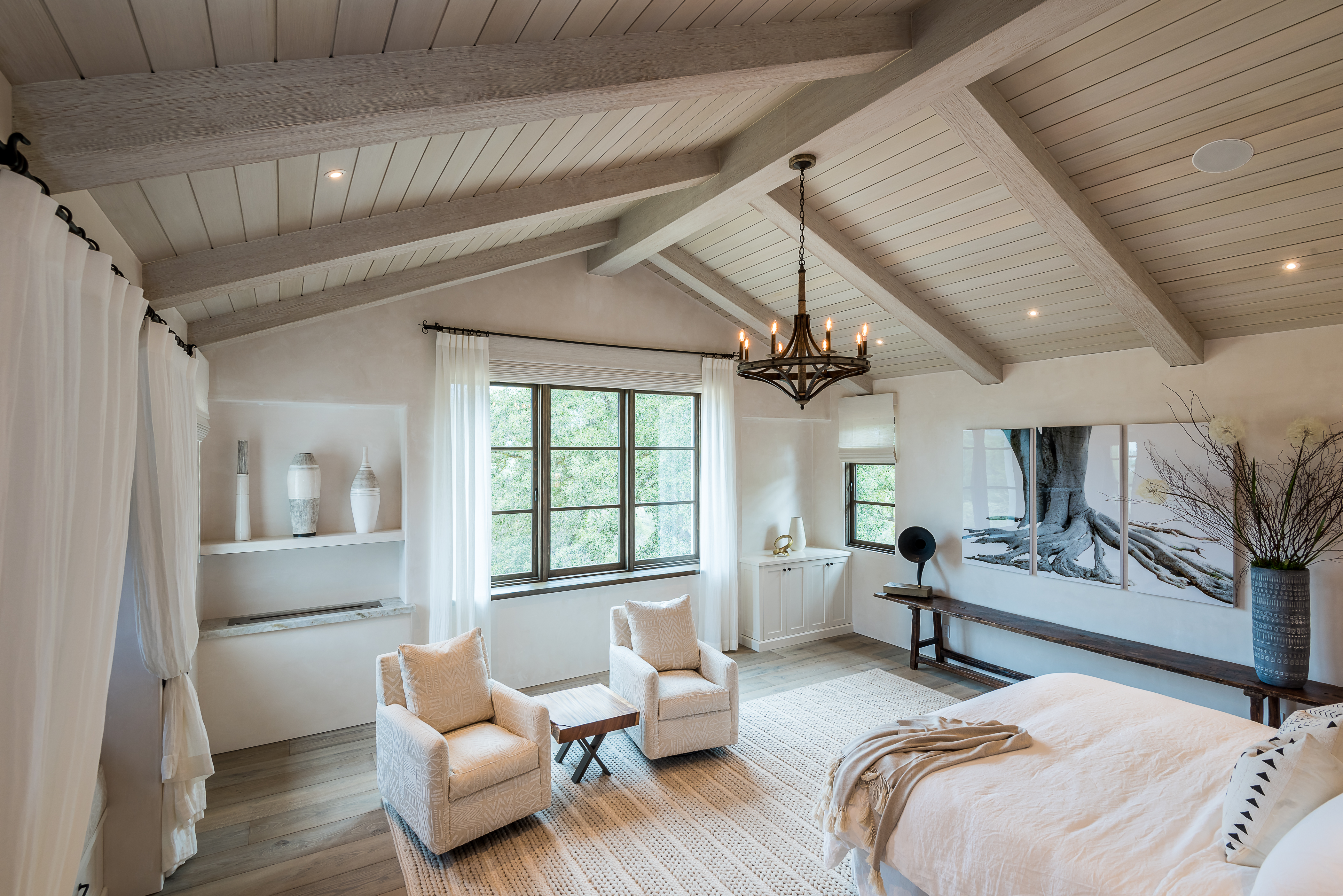 Light and bright vaulted ceiling beams in a farmhouse-inspired bedroom