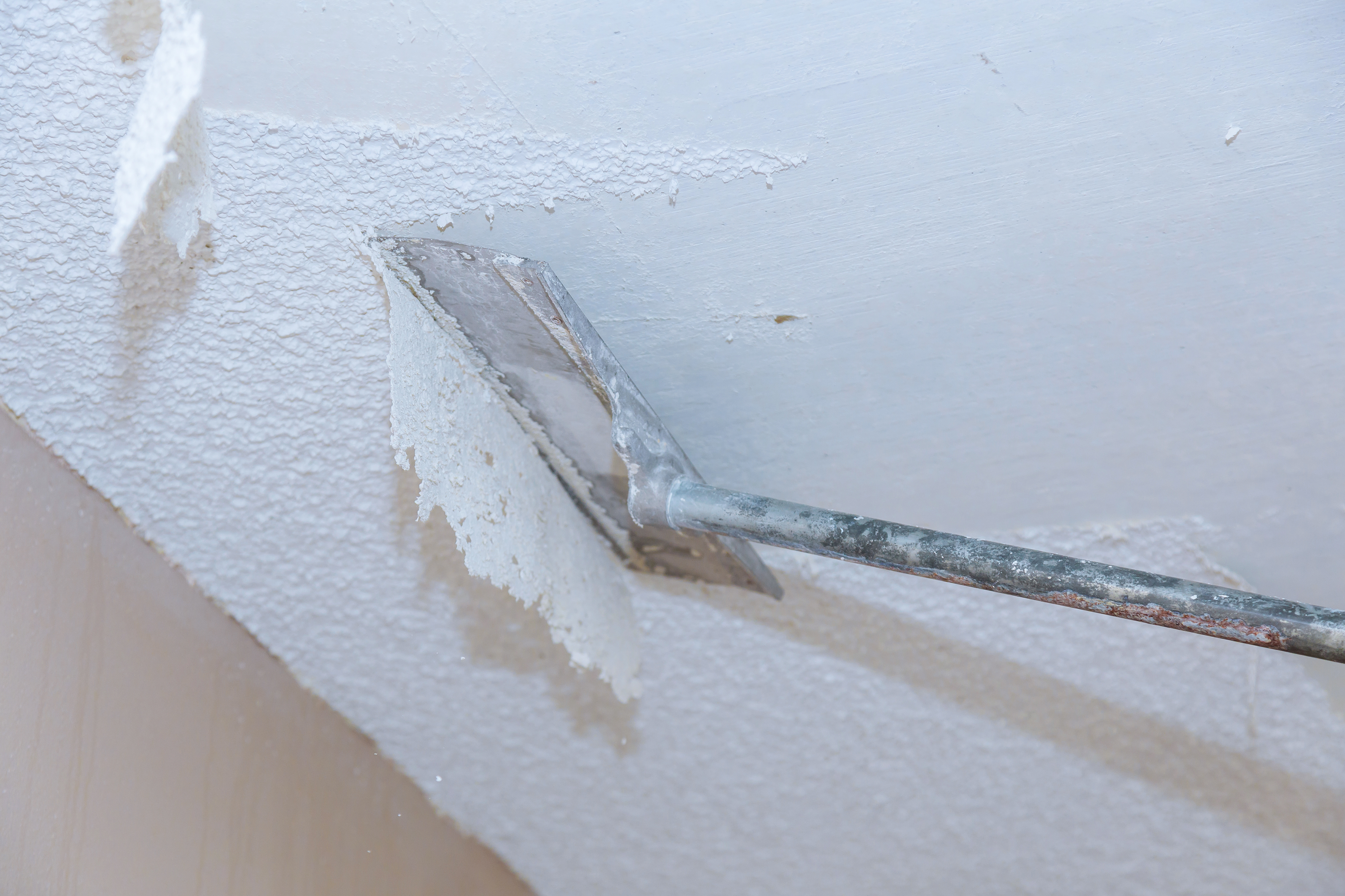 Popcorn removal is not required to install planks over a popcorn ceiling.