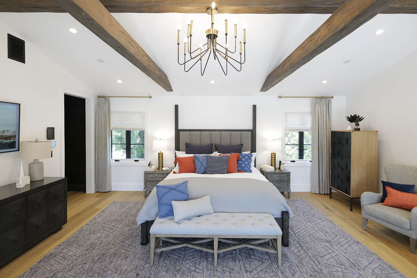Bedroom with ceiling beams along the center of the ceiling.