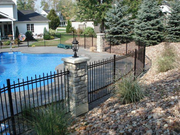 Ashford Tumbled Stone post covers in Calico beautifully accent this property's split rail fence: