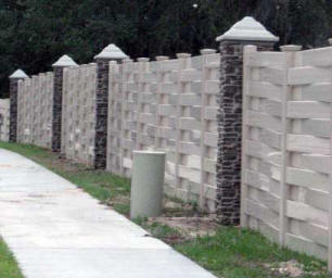 Ashford Ledgestone columns in Brown with optional column caps provide a bold touch to this large privacy fence: