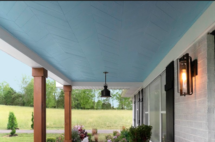 Chevron faux wood wall panels on a covered porch ceiling