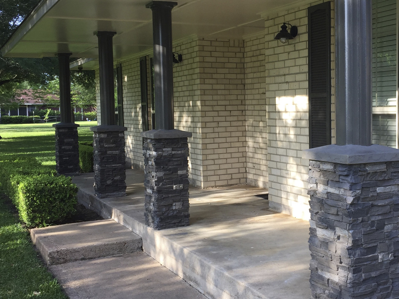 Exterior faux stone column wraps provide grandeur to the front entrance of a home.