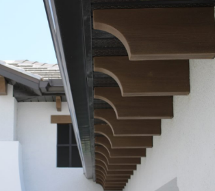 Faux corbels under a roof line add a charming accent to the exterior home design.