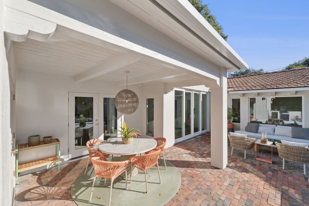 A stunning back patio with warm architectural detailing, layered textures, and elevated finishes