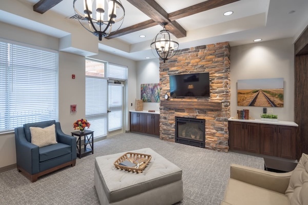 Heritage Faux Wood Beams in Dark Walnut form a partial coffered layout across a recessed ceiling in a commercial lounge area.