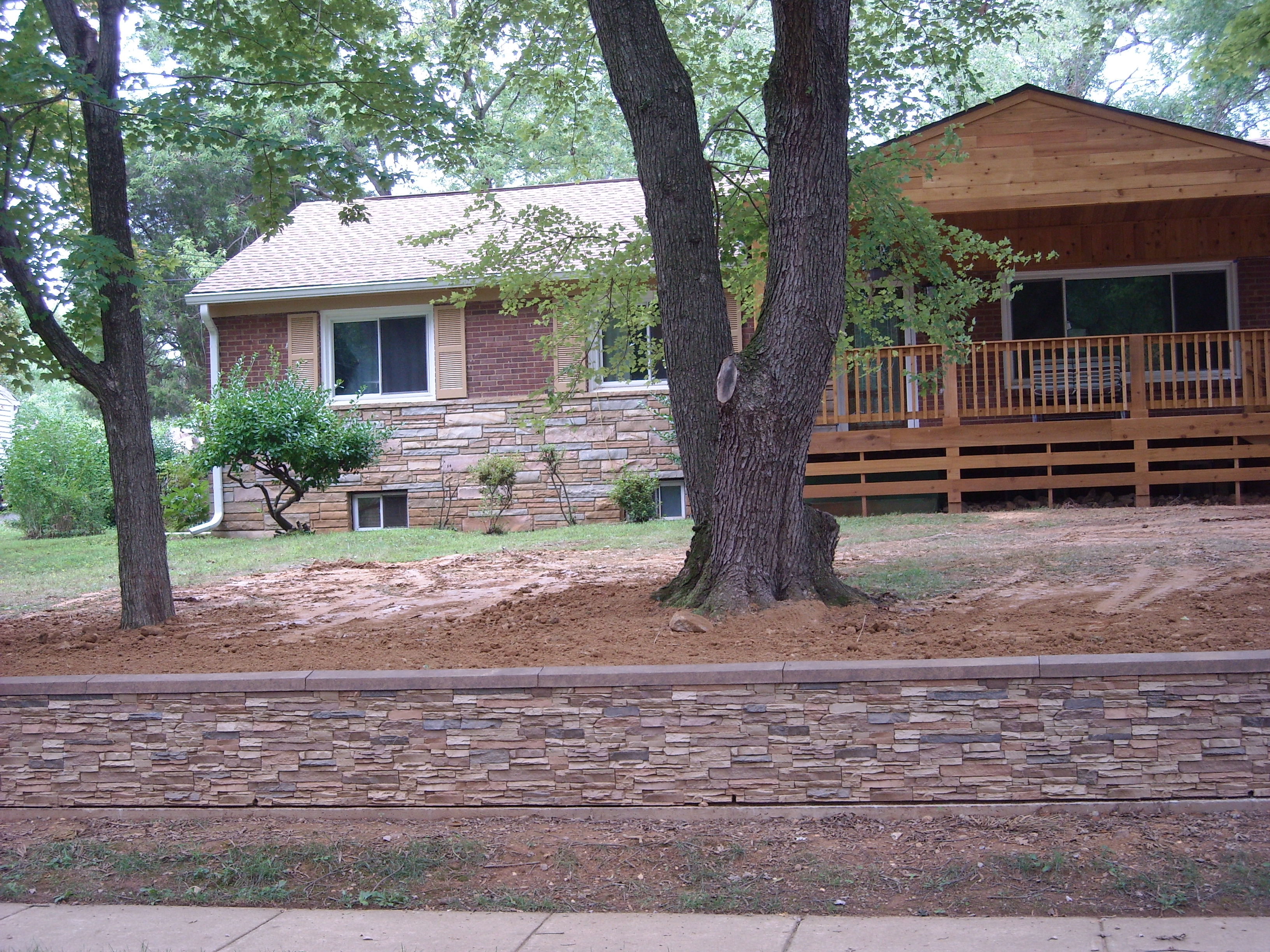 The wall was built to match the existing stone details of Ray's home.