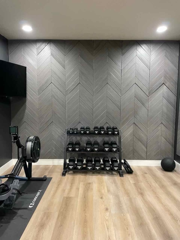 Graphite lead chevron faux wood wall panels in a modern style home gym with clean lines and textured accent wall