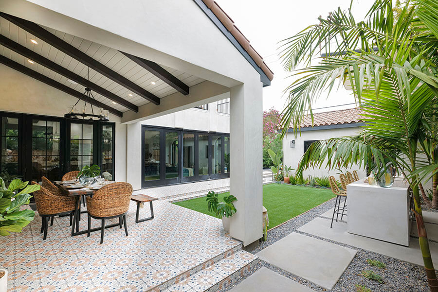 Faux wood beams on a porch ceiling add a warm touch to the exterior home design.