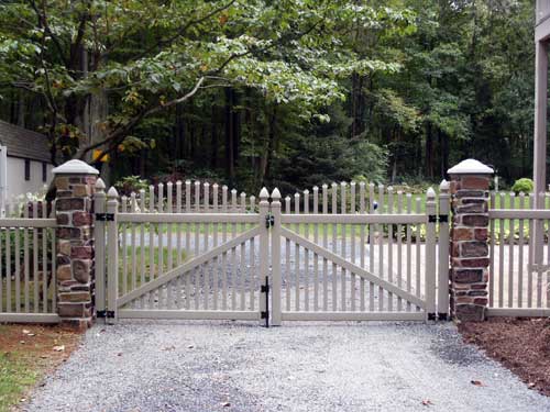 Faux stone entrance columns as gate and fence posts