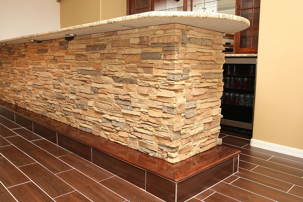 Colorado stacked stone tall desert sand faux panels on home bar island