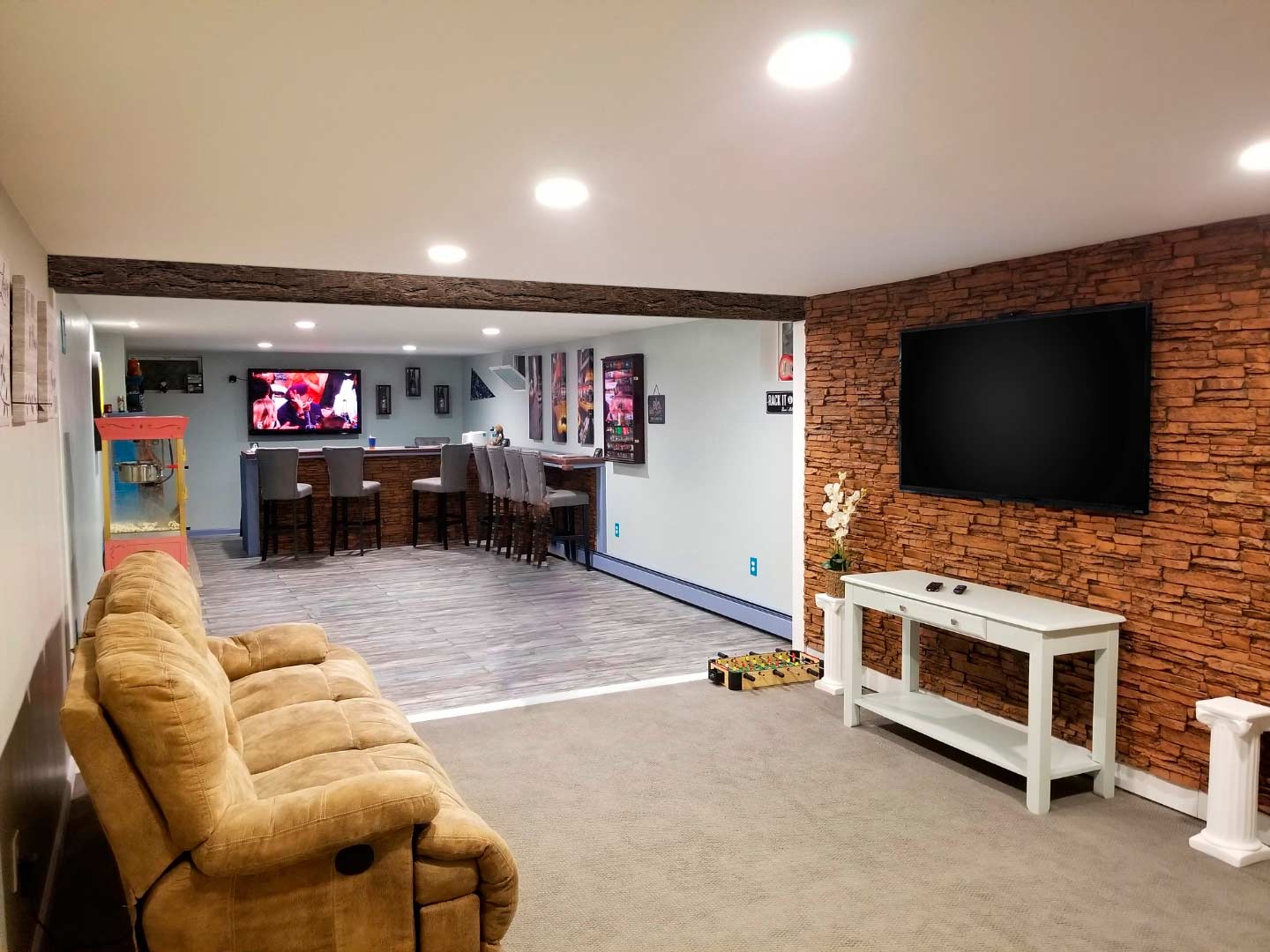 installing faux panels on a concrete basement wall creates a sophisticated focal wall to mount a TV