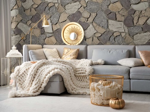 Anson Fieldstone Faux Stone Wall Panels in Mist installed on a living room wall