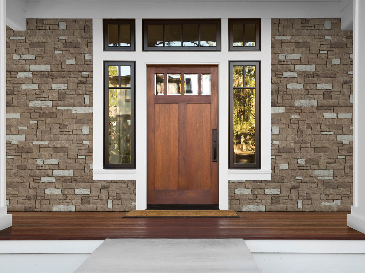 Faux stone siding around the front door and front section of a house