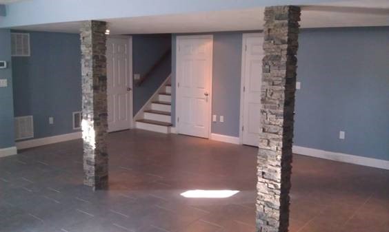Stacked faux stone columns adding beauty to existing basement supports