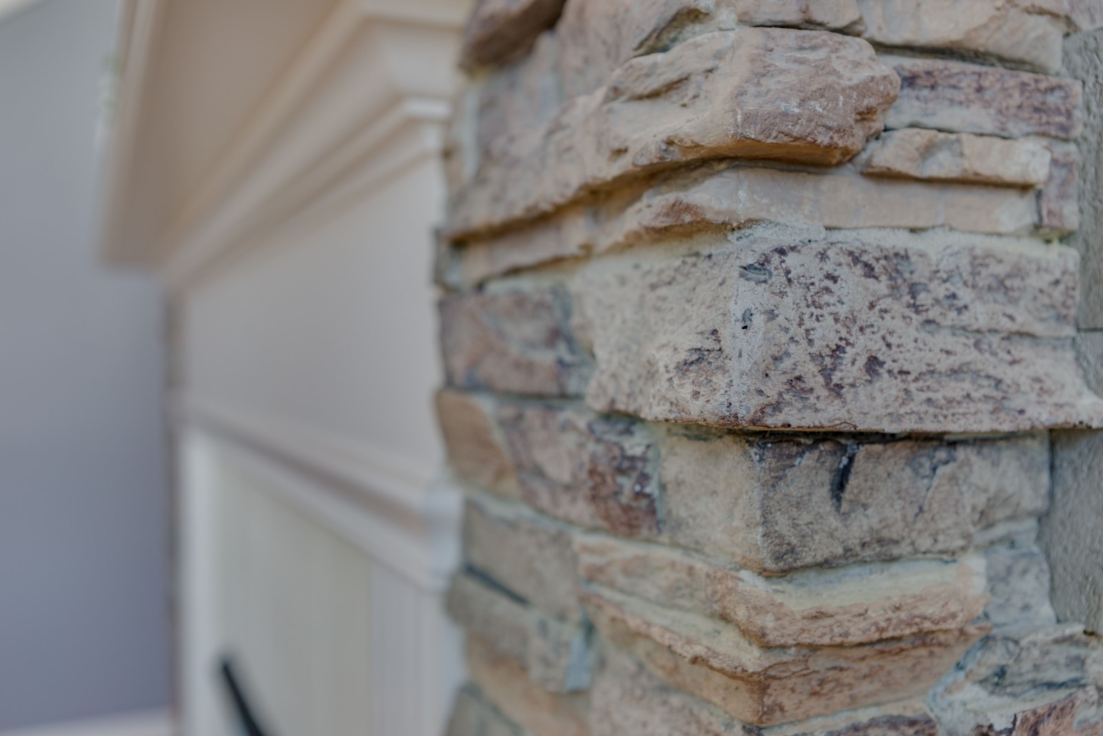 An exterior faux stone column has the texture and look of real stone.