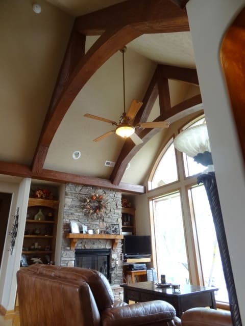 Curved faux truss beams add flair to this media room.