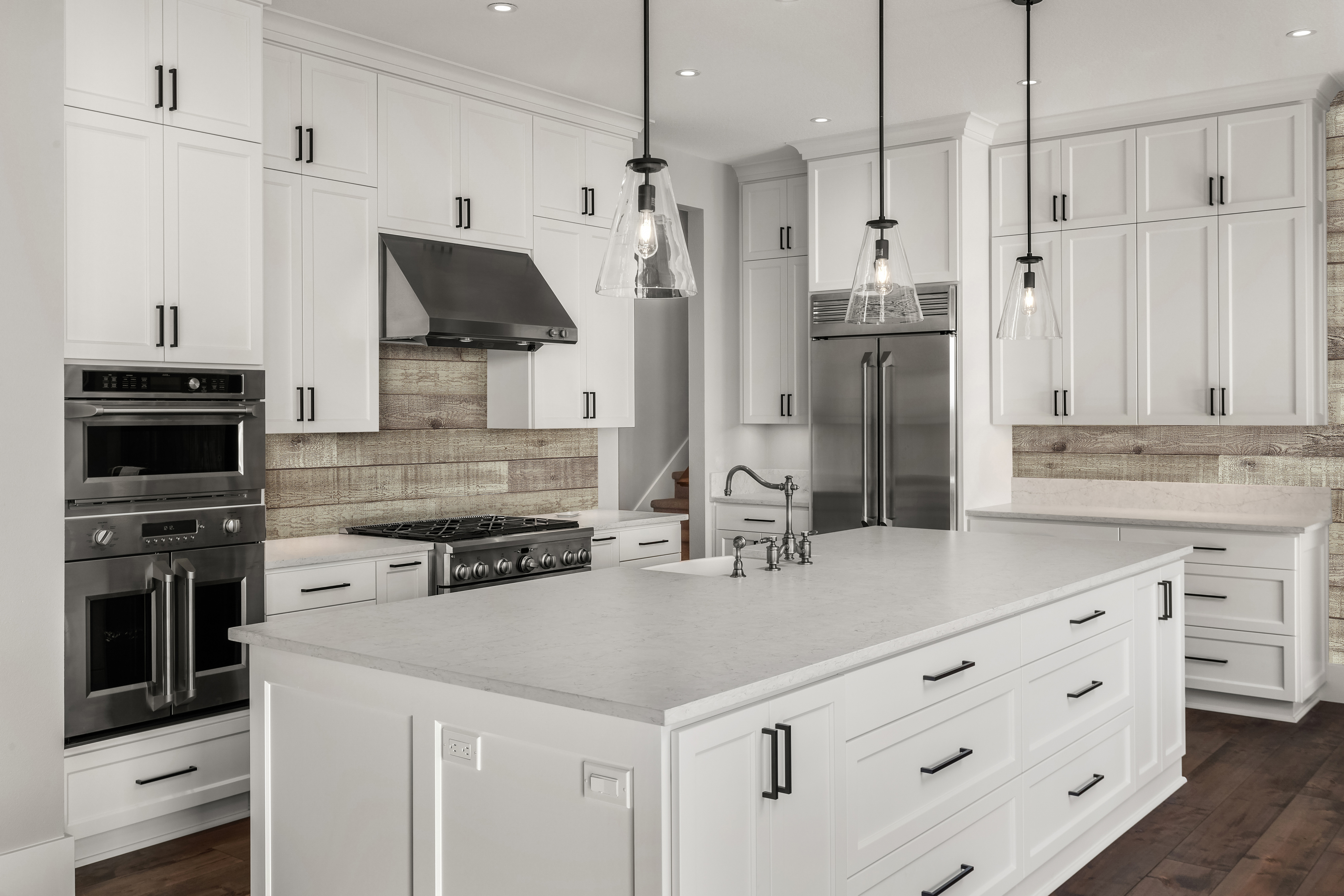 A kitchen with white cabinetry and Reclaimed Shiplap Faux Barn Wood Wall Panels as a backsplash