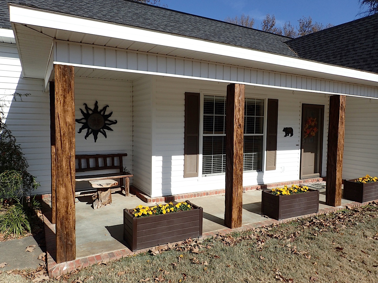 Porch posts covered with faux wood beams.