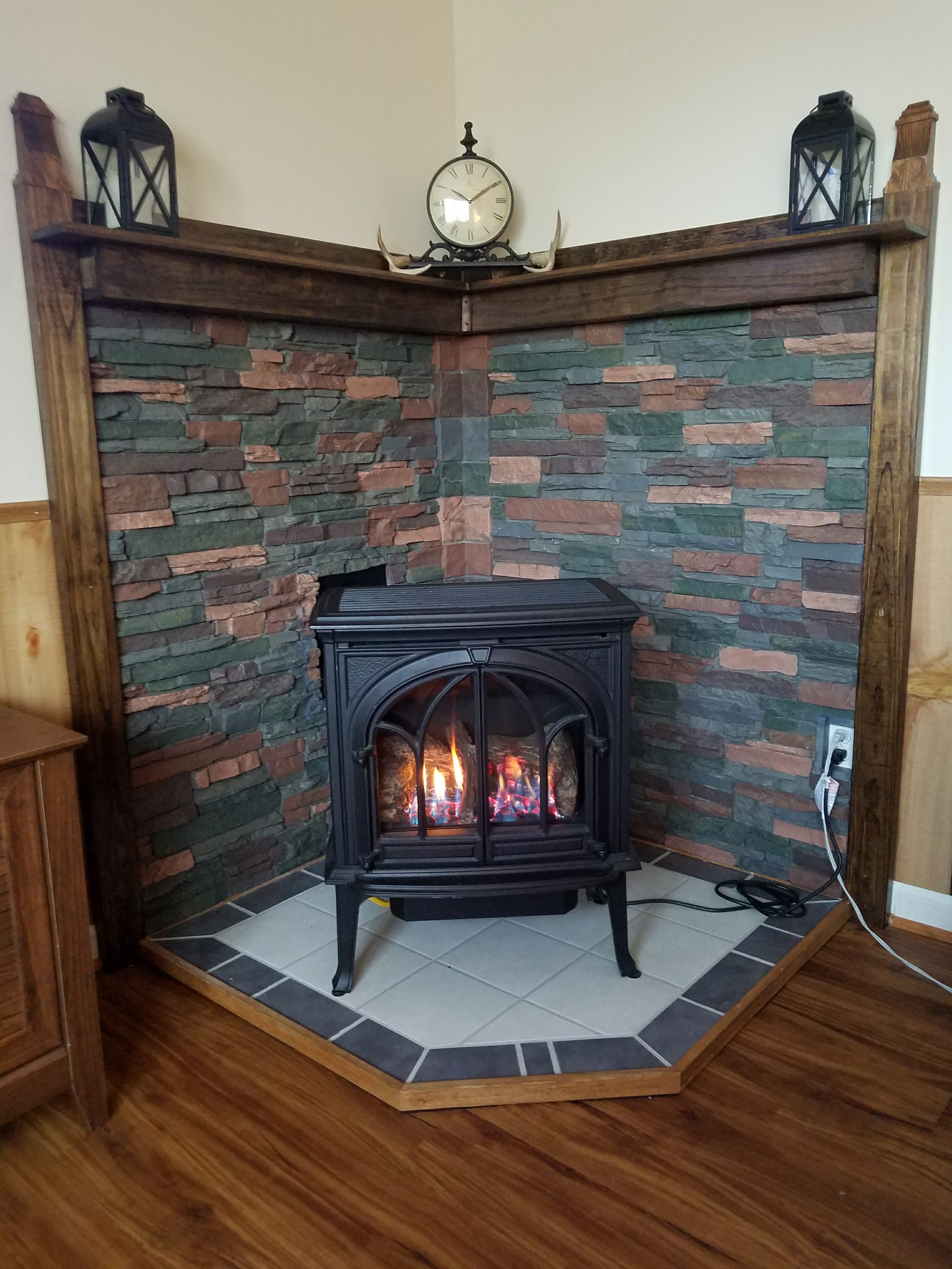 faux stone fireplace surround with universal flush in center.