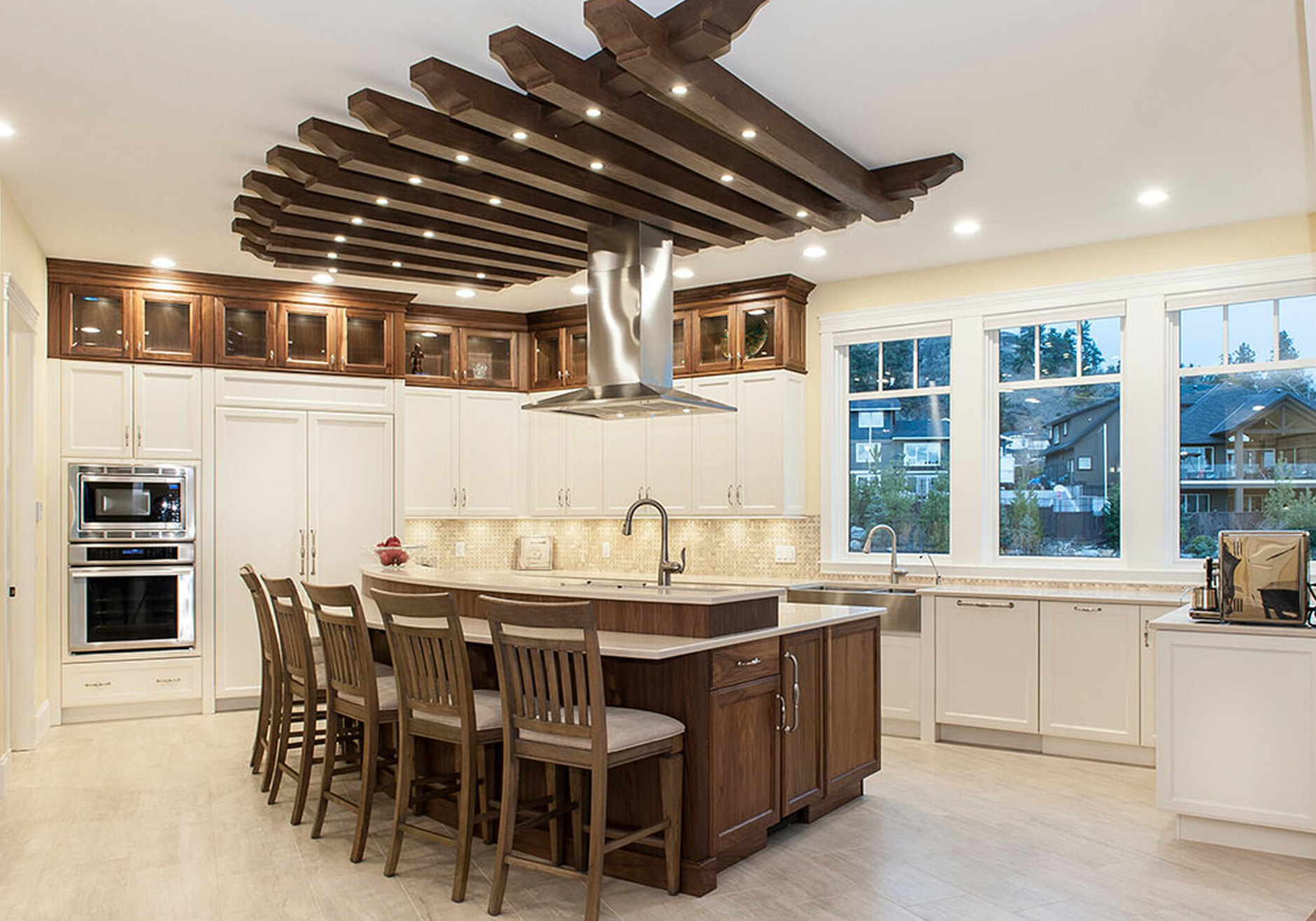 Faux wood ceiling beams with LED recessed lights above a kitchen island