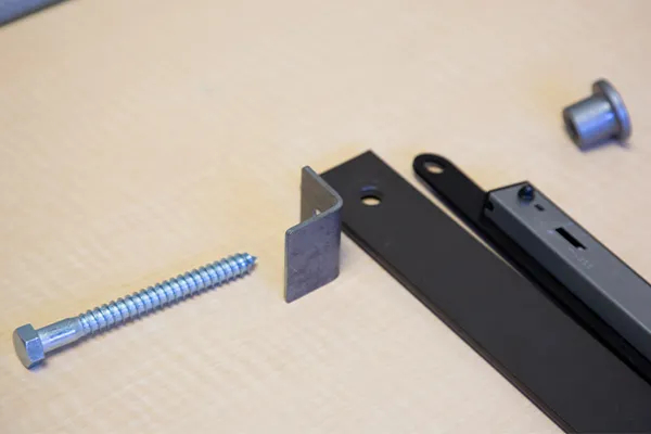 A hex lag bolt, an attached soft stop and bracket, a barn door flat track, and a standoff base. A hex lag bolt, an attached soft stop and bracket, a barn door flat track, and a standoff base.