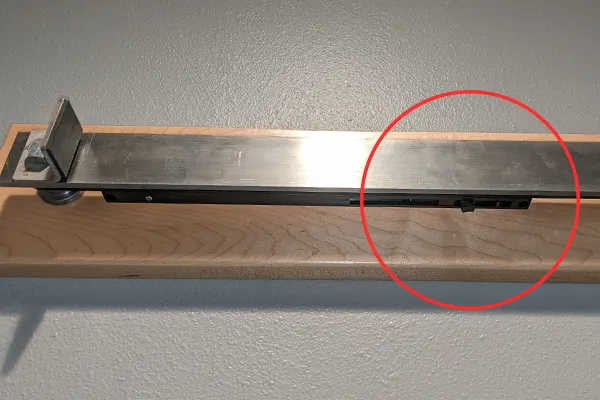 Attaching the flat track to the wall or ledger board, underside view Attaching the flat track to the wall or ledger board, underside view