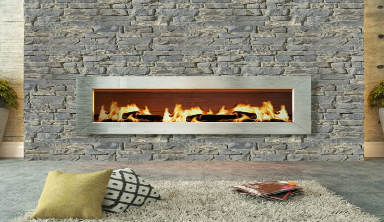 a stacked stone faux wall panel surrounding a living room gas fireplace