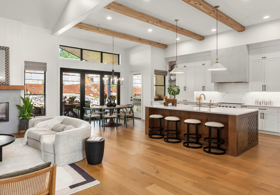 Unfinished smooth wood beams in a spring theme living room and kitchen area