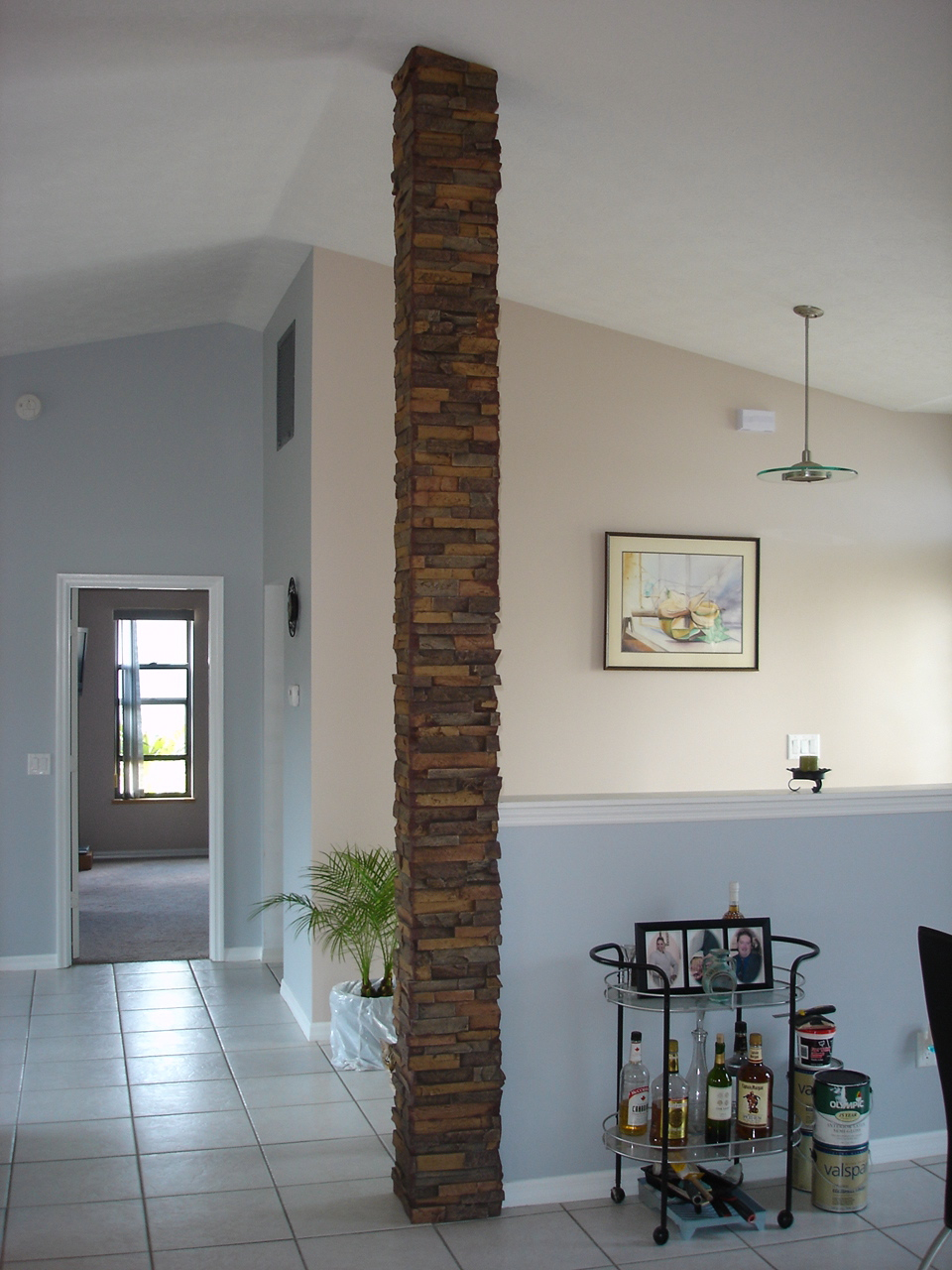 Faux stone column wrap making existing kitchen support more attractive